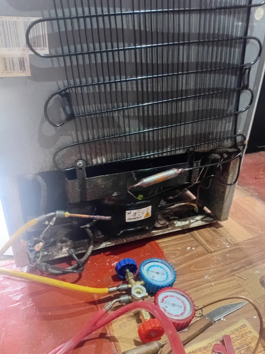 Fridge repair technician at work